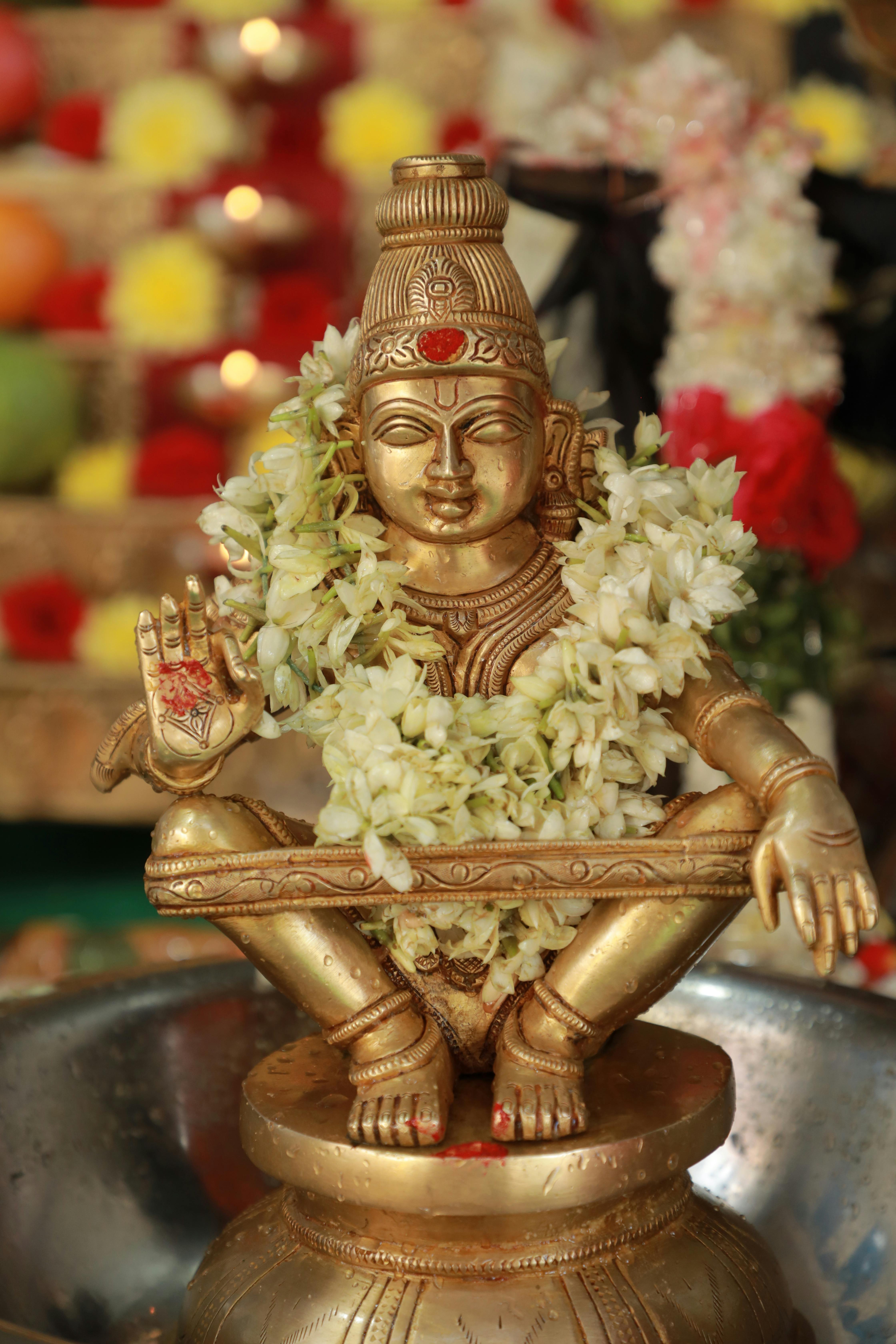 Golden Lord Ayyappa image decorated with flowers
